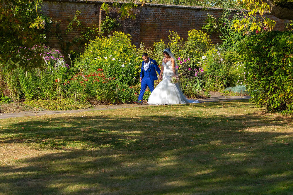 Bride and groom walking in the park