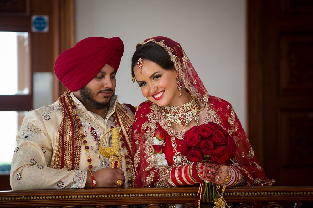 Bride and groom in Indian clothes sitting