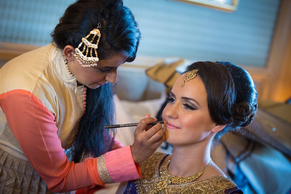 Make-up artist preparing the bride