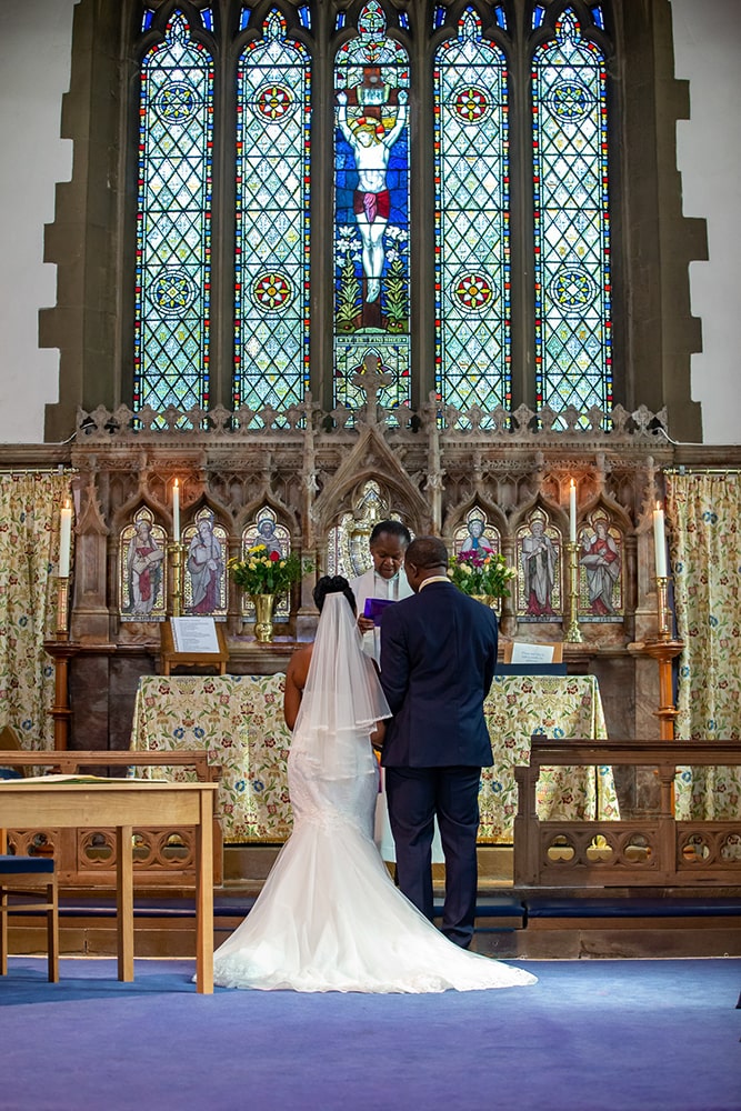 Bride and groom standing before the altar at church